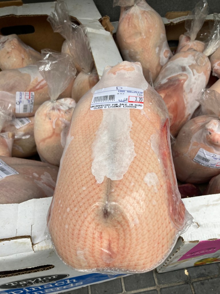 Silver Appleyard duck roast, vacuum packed and frozen, on display above a box of packaged ducks for roasting